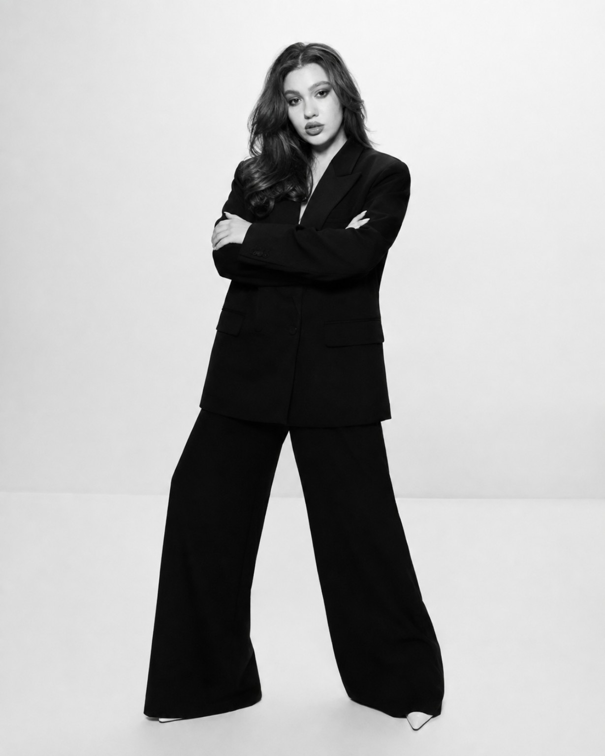 Ana Vladu, founder of The Antet Studio, wearing a black suit against a light background.